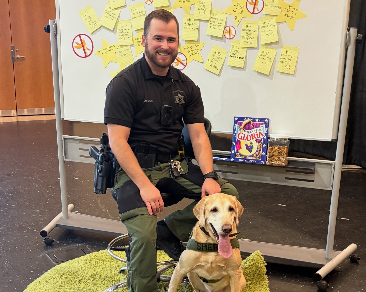 An office poses for a picture with his K9 partner. 