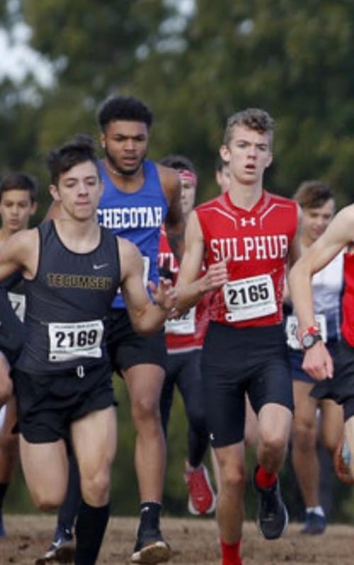 A group of men running in a cross country race