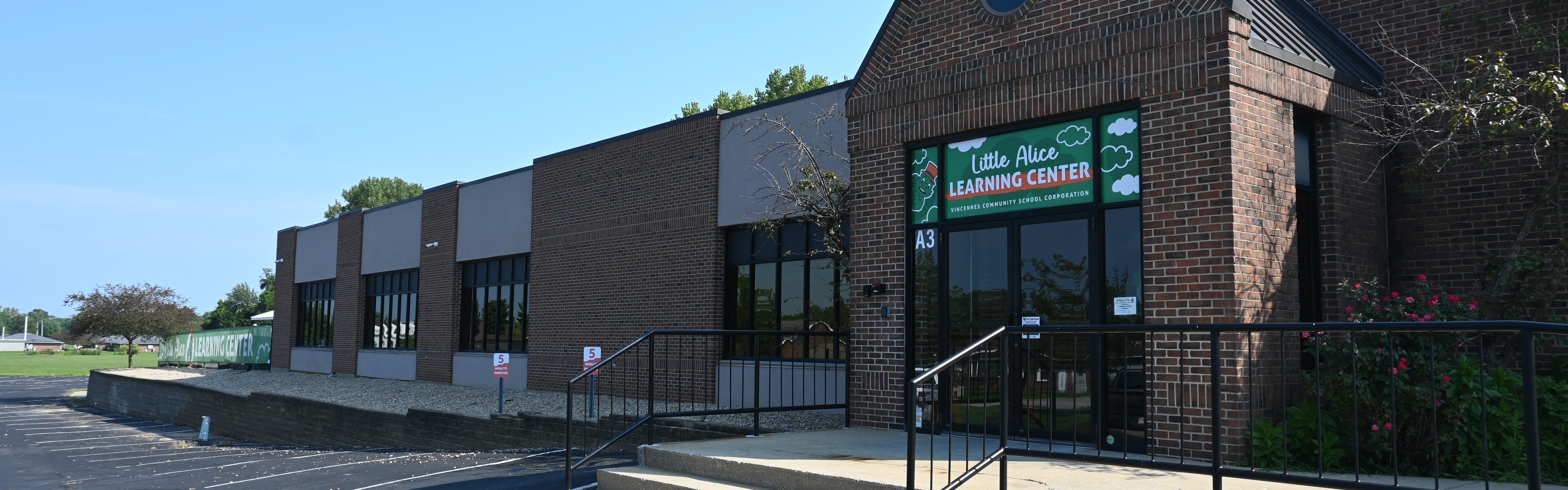 Brick Building that has a sign above door that reads Little Alice Learning Center