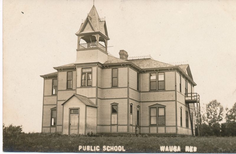 Historic school building with clock tower, showcasing architectural beauty and timeless elegance.