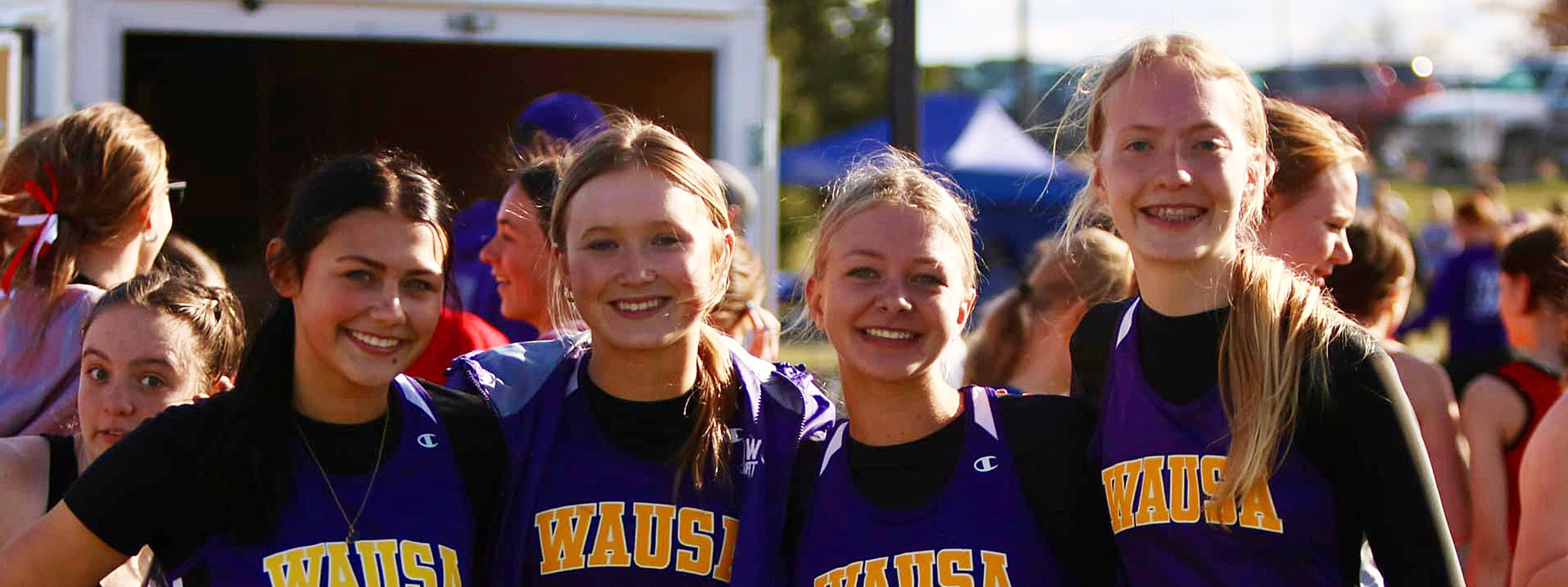  A group of girls energetically sprinting over hurdles on a track, showcasing their athleticism and teamwork.