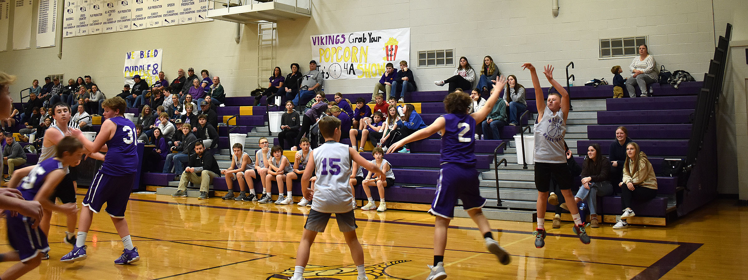 A group of people playing basketball in a gym.