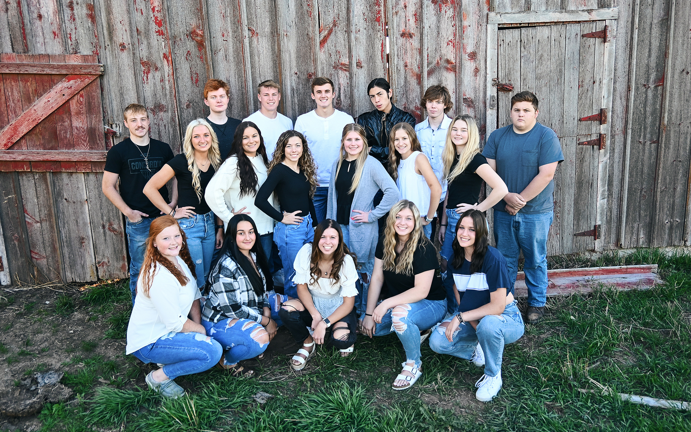 A group of high school seniors smiling and posing for a class photo.