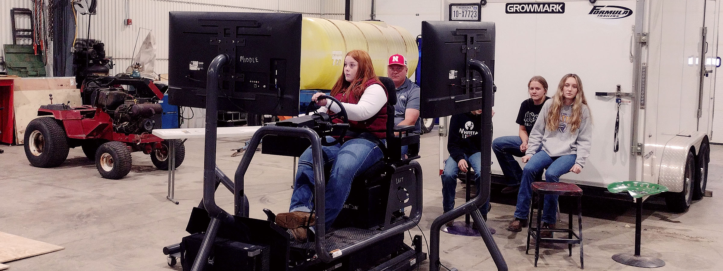  A diverse group of people enjoying a moment together while seated on a large, industrial machine outdoors.