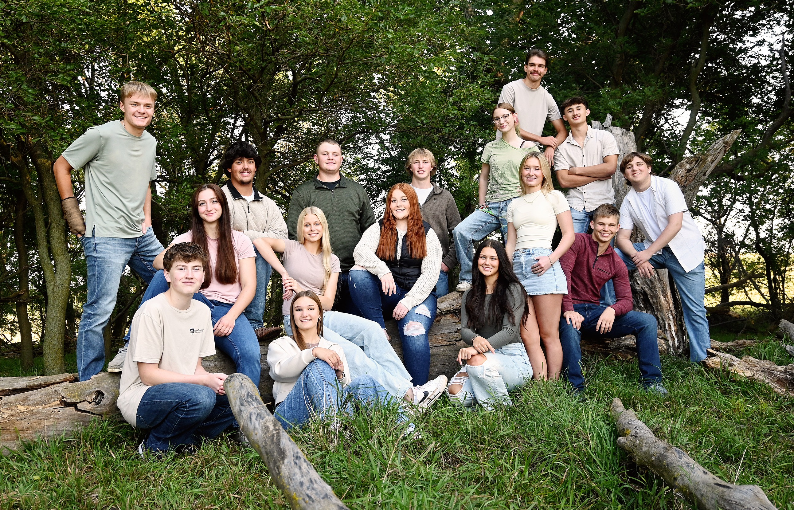 A diverse group of young individuals sitting on bleachers, chatting and laughing together.