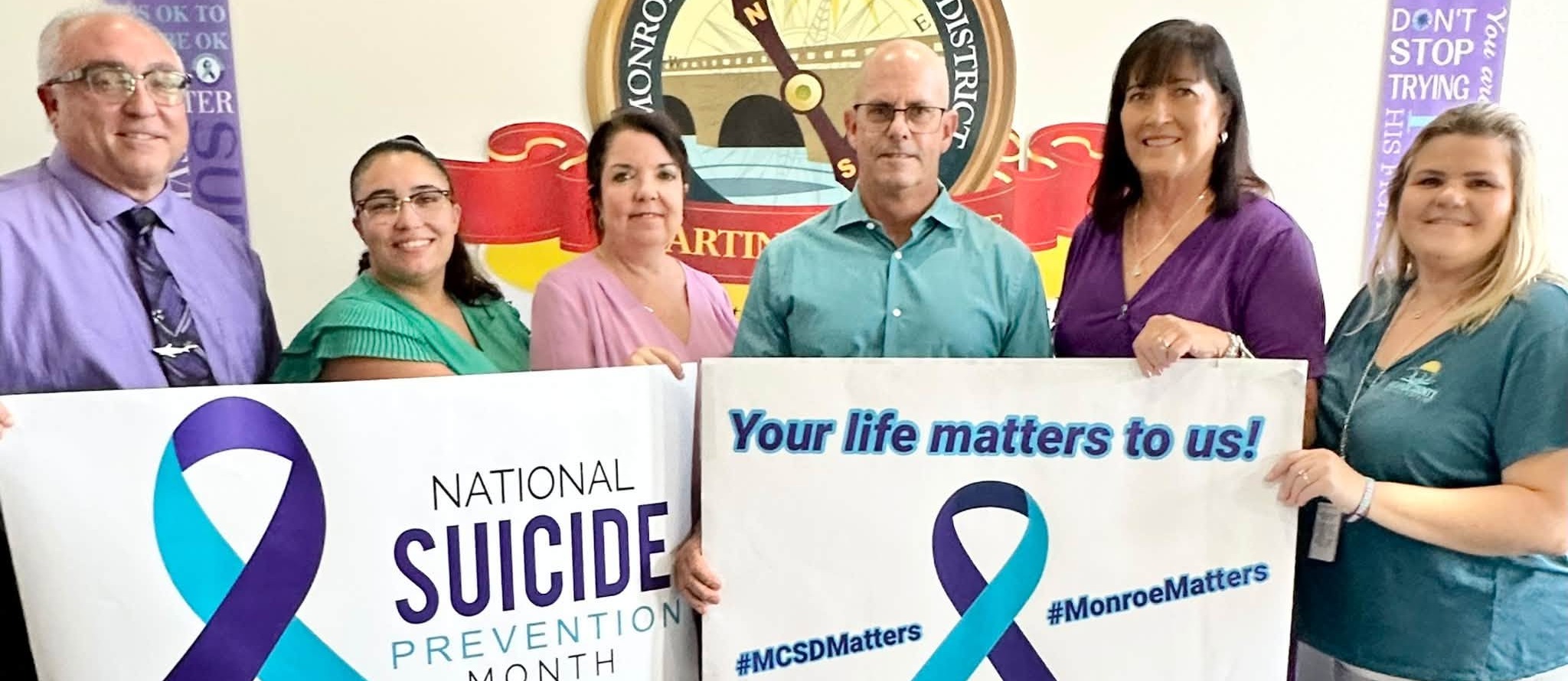 Suicide Prevention banner held by Admin personnel