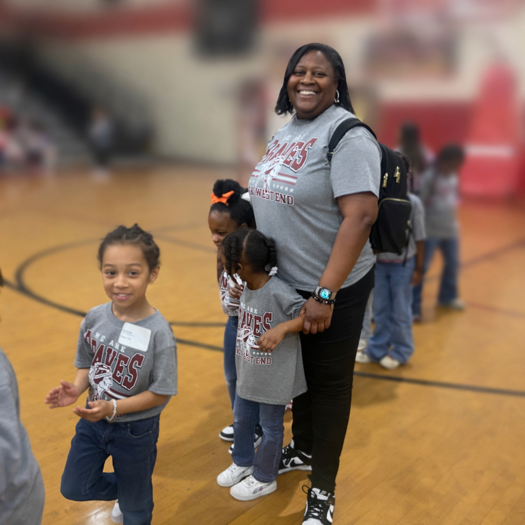 Teacher standing with children in the gymnasium