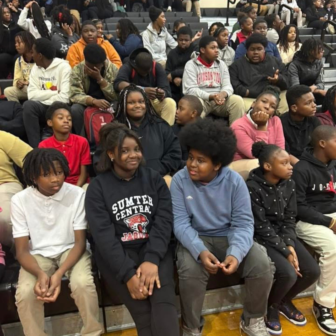 students sitting in the gymnasium