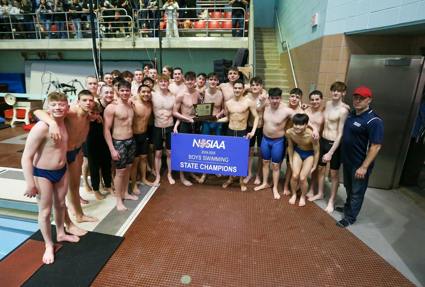 Boys by a swimming pool with a trophy