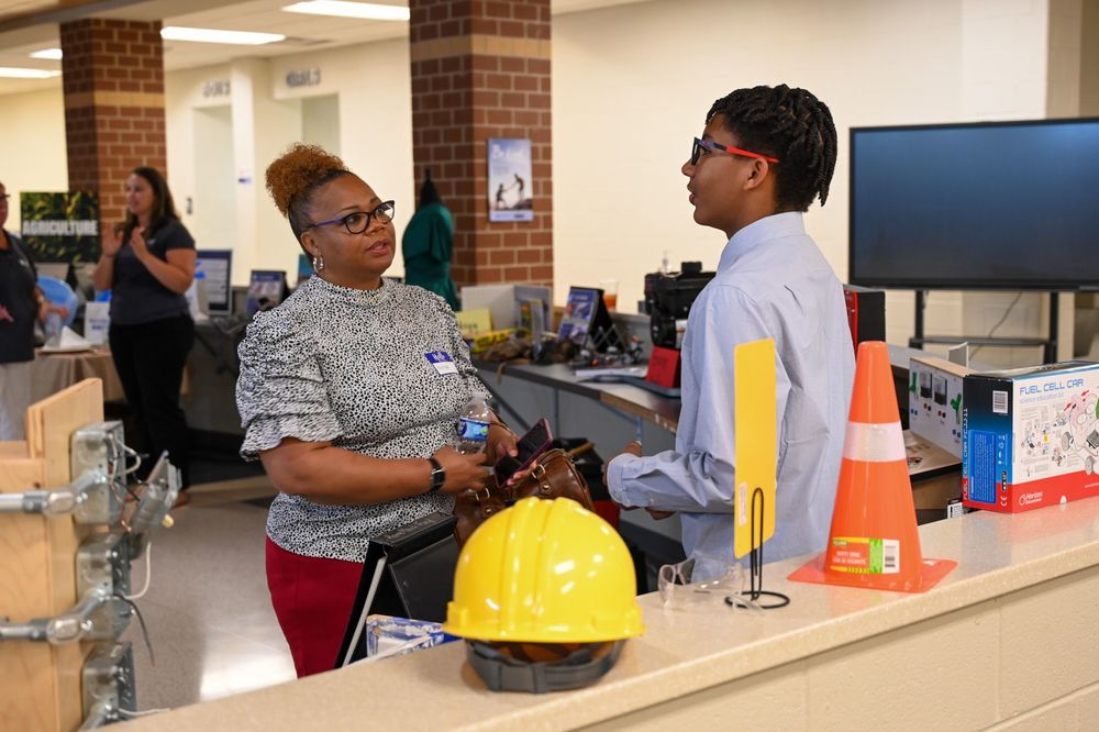 Business partner talking to student