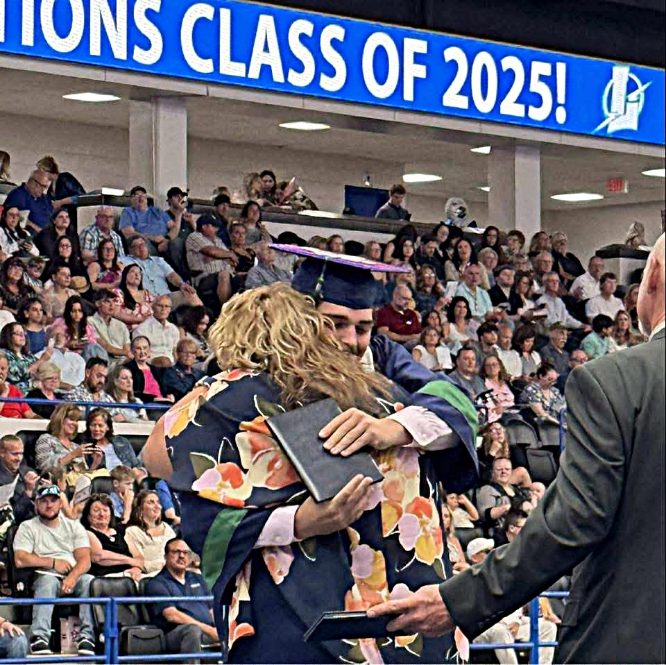 High school graduation photo of a mom hugging her son