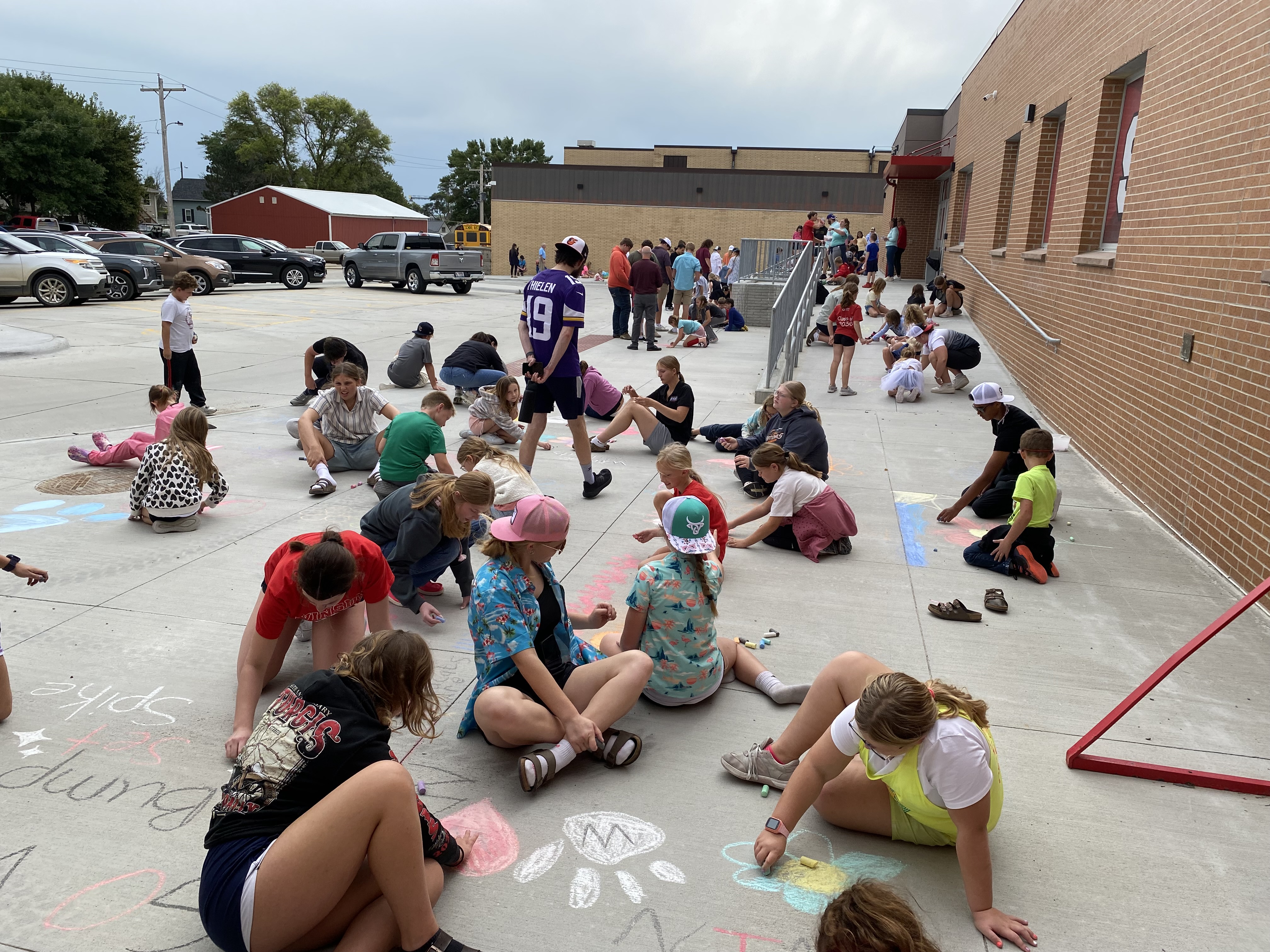The 4th and 9th graders working on chalk art