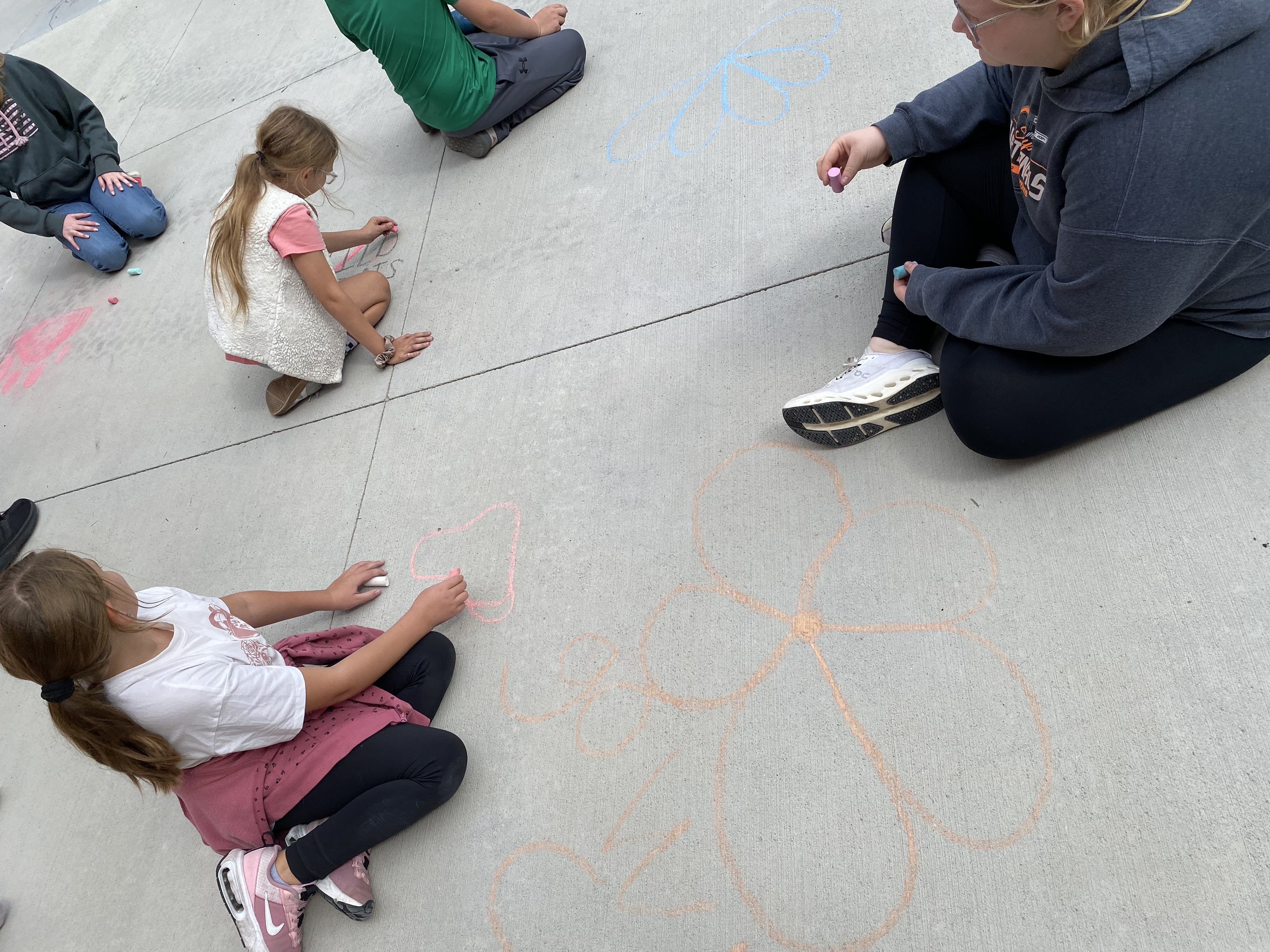 The 4th and 9th graders working on chalk art