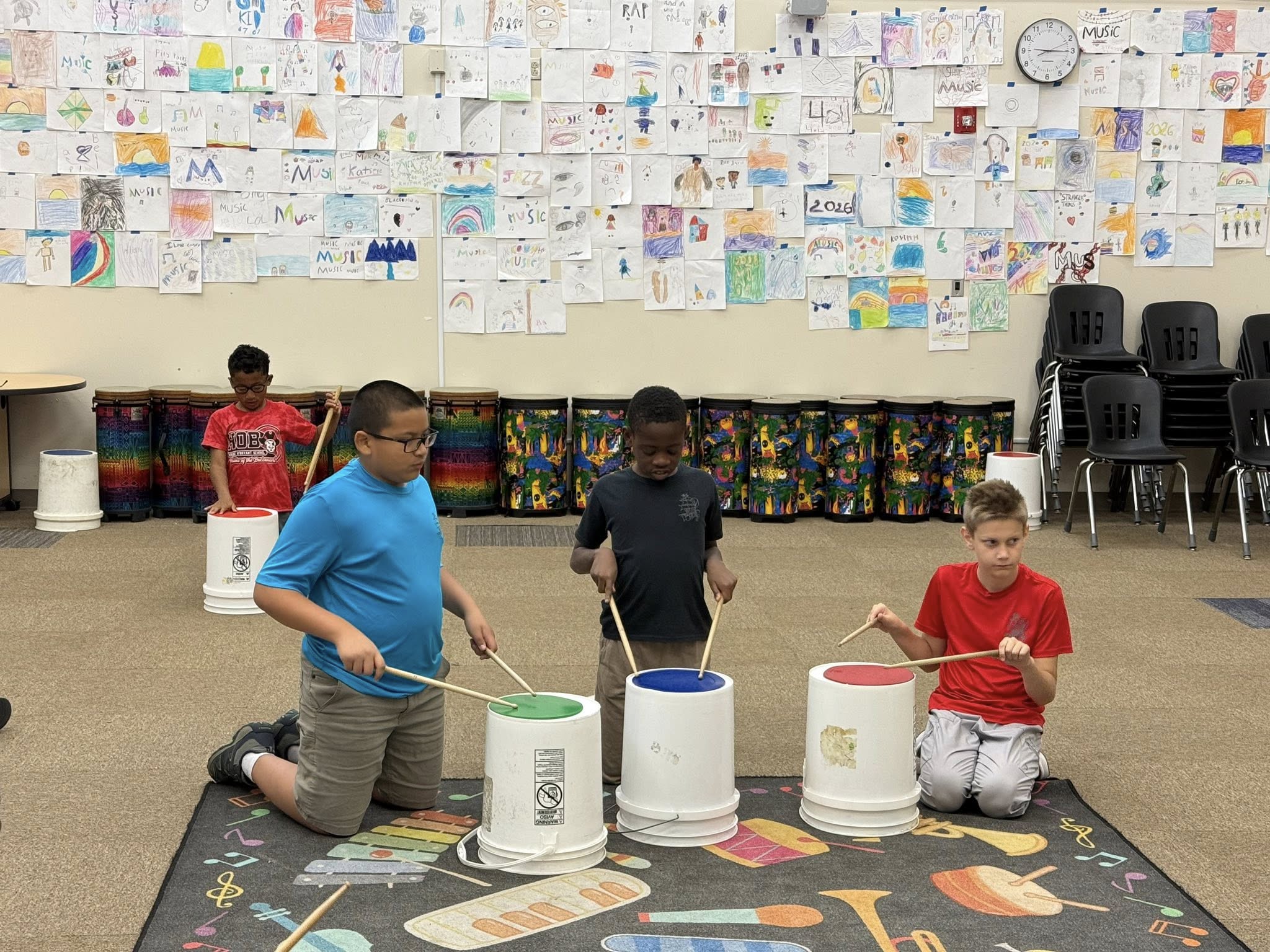Students making music on buckets