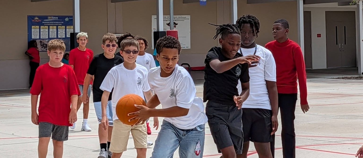 middle schoolers playing basketball at lunch
