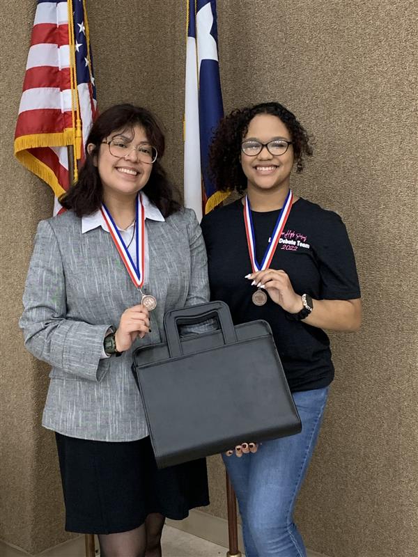 2 girls student wearing their medal