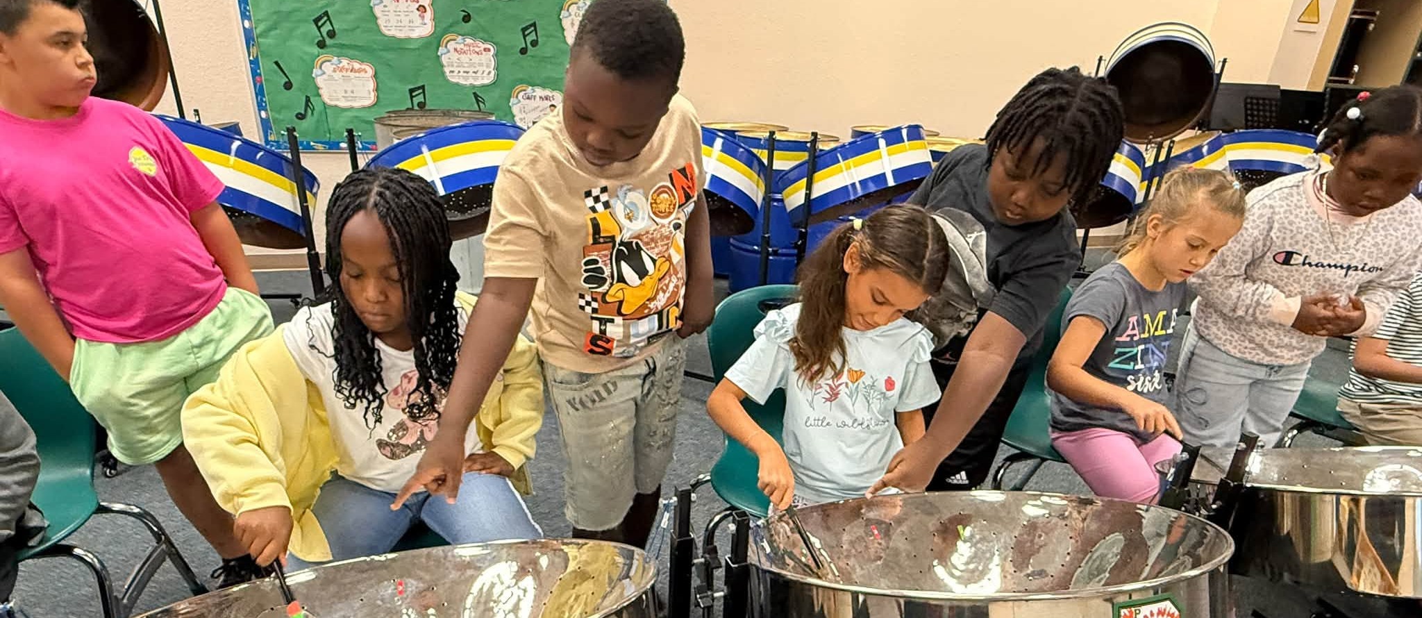 Students learning steel pan in music class