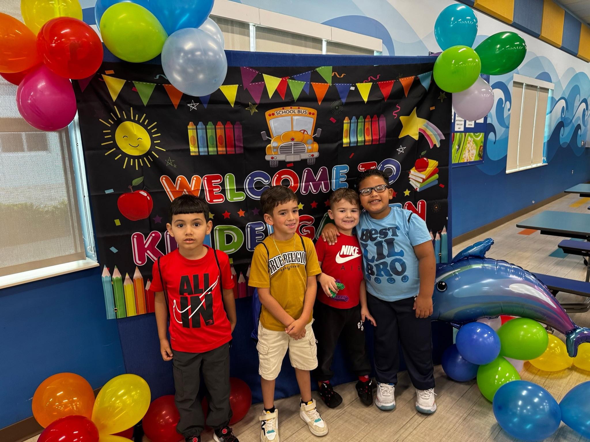 Kids in front of kindergarten sign