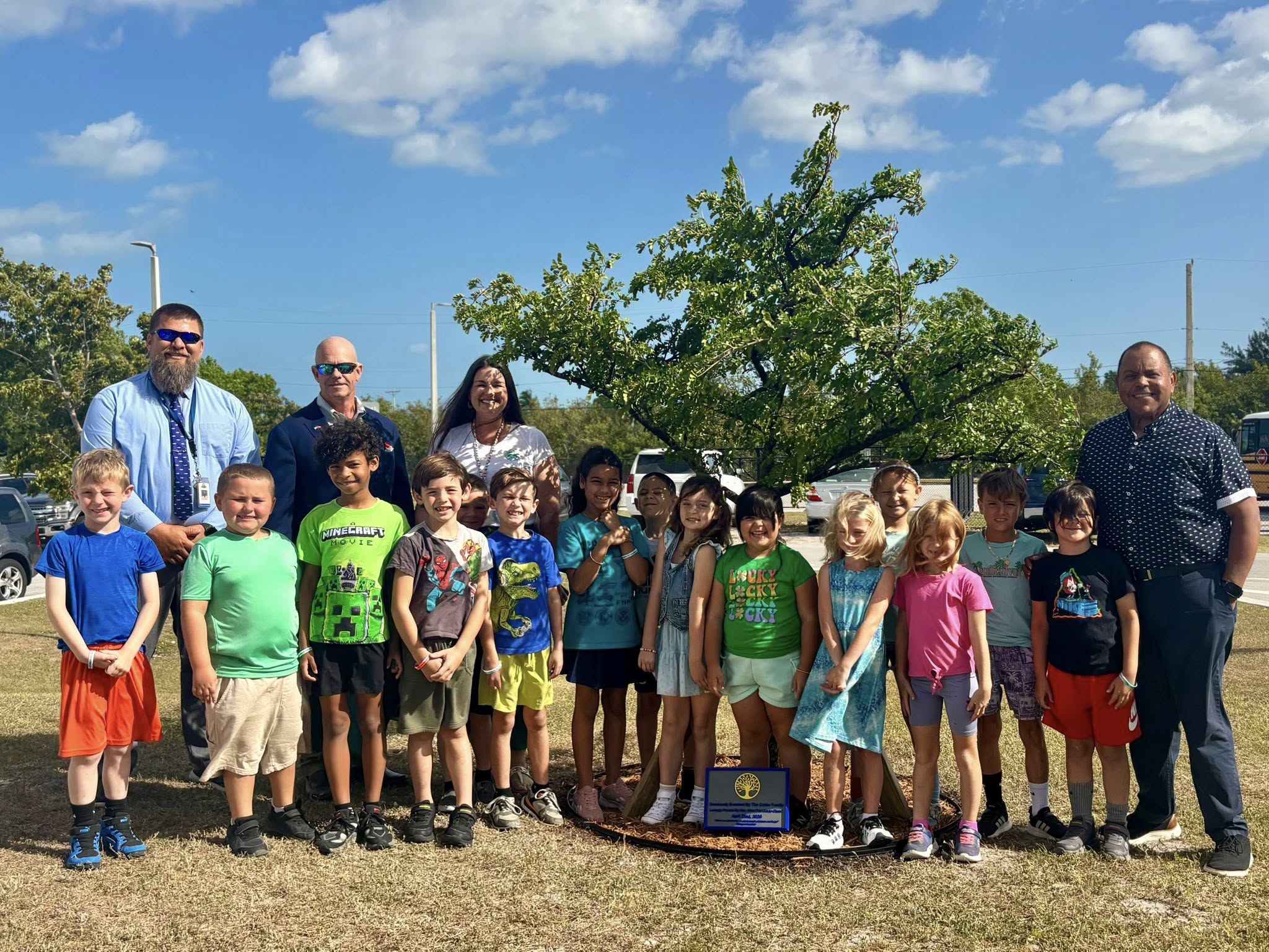 Group planting a tree for earth day