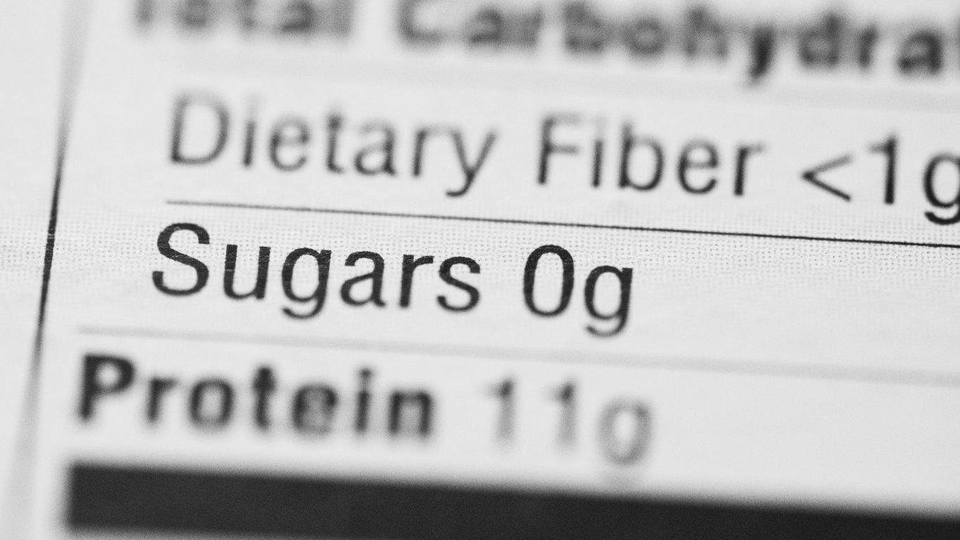 A close-up view of a nutrition label highlighting the 'Sugars' entry, which indicates '0g' of sugars, along with other nutritional information such as 'Dietary Fiber' and 'Protein'.