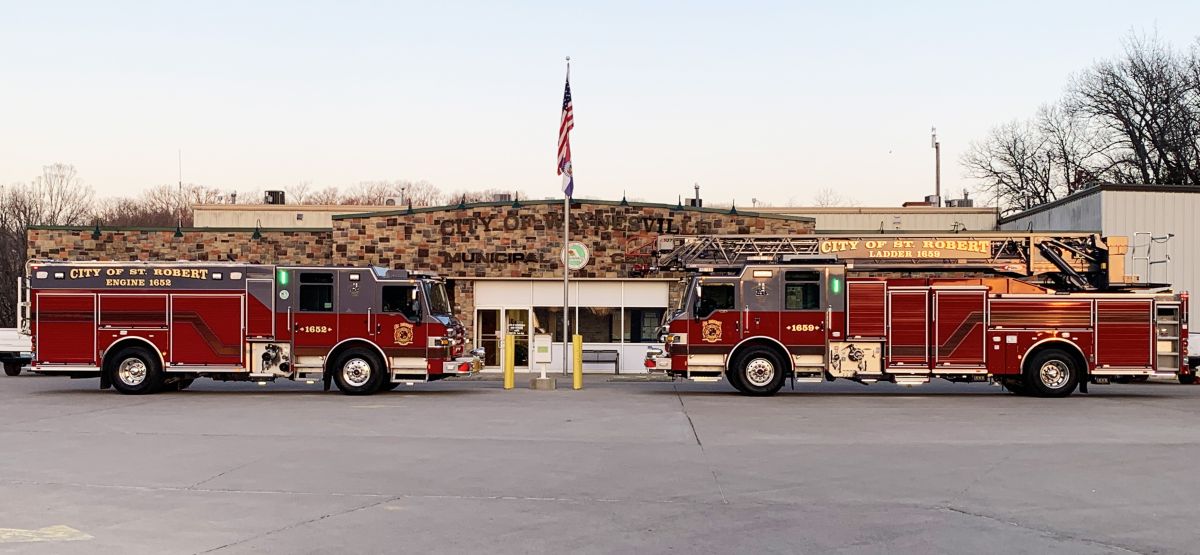 Two fire trucks parked outside a building