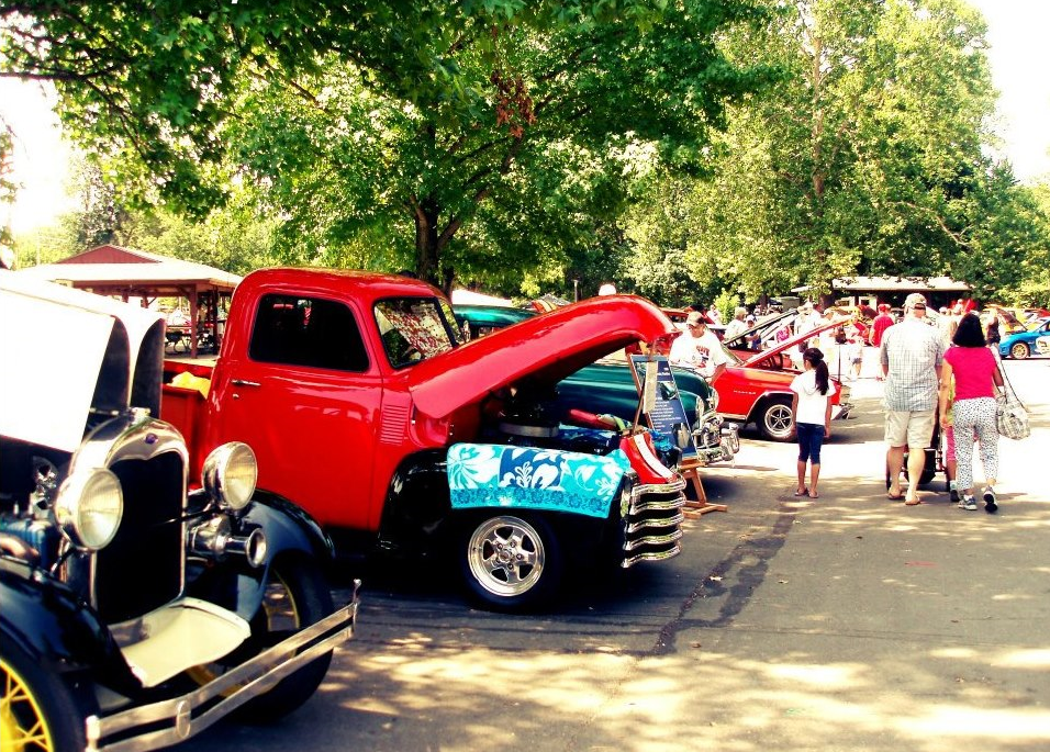 A group of people gathered around a vintage car