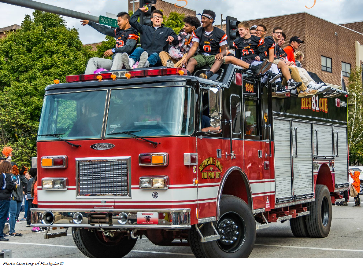 A fire truck with several people on board