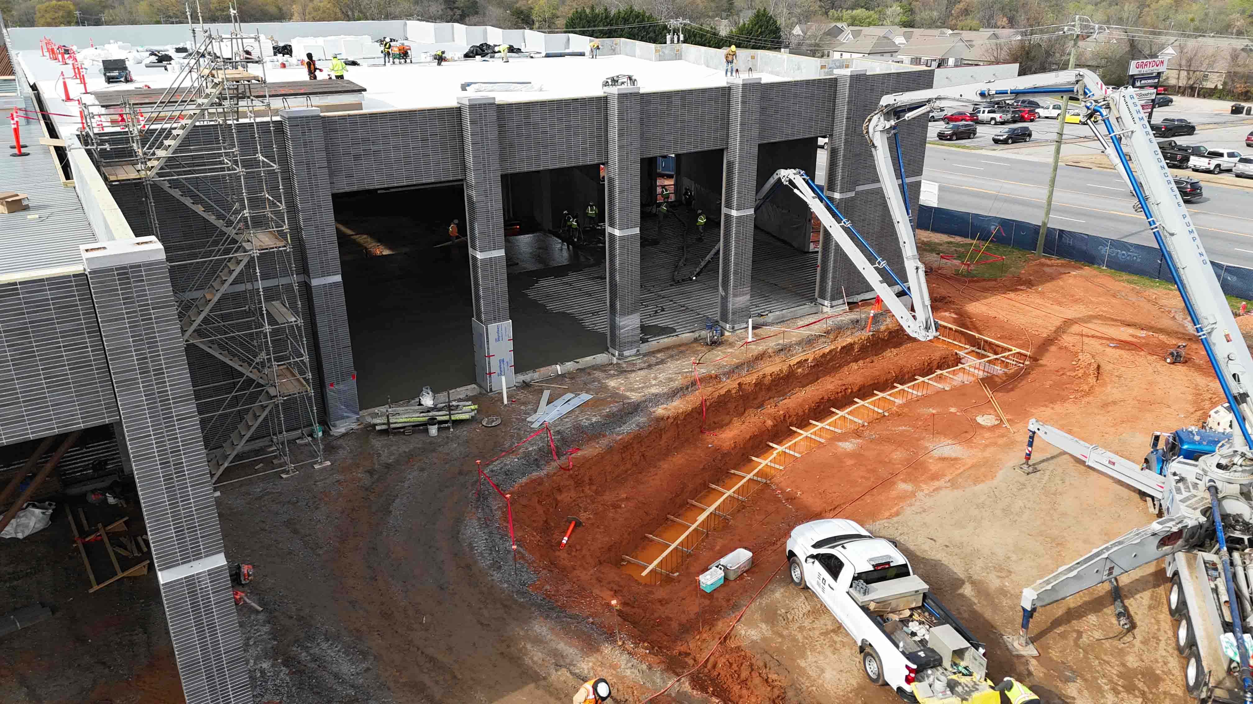 Drone shot of the Greer Sports and Events Center construction showing concrete walls and construction trucks