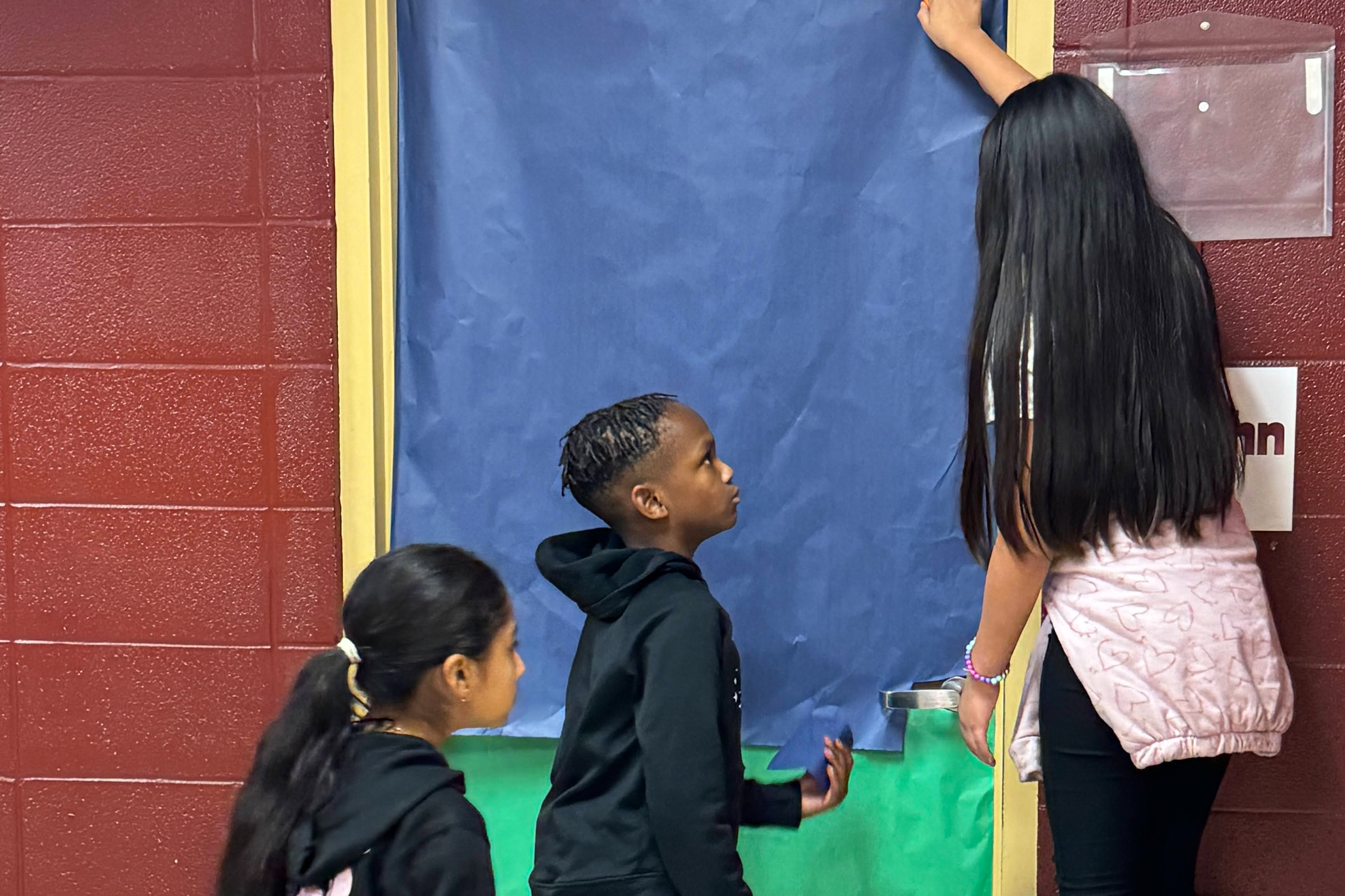 students decorating a classroom door