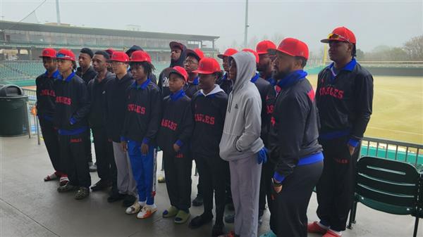 A team of athletes posing for a photo on a sports field.