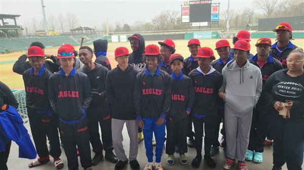 Baseball team posing together on the field.