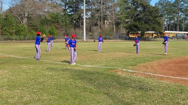 A group of baseball players warming up on the field before a game.