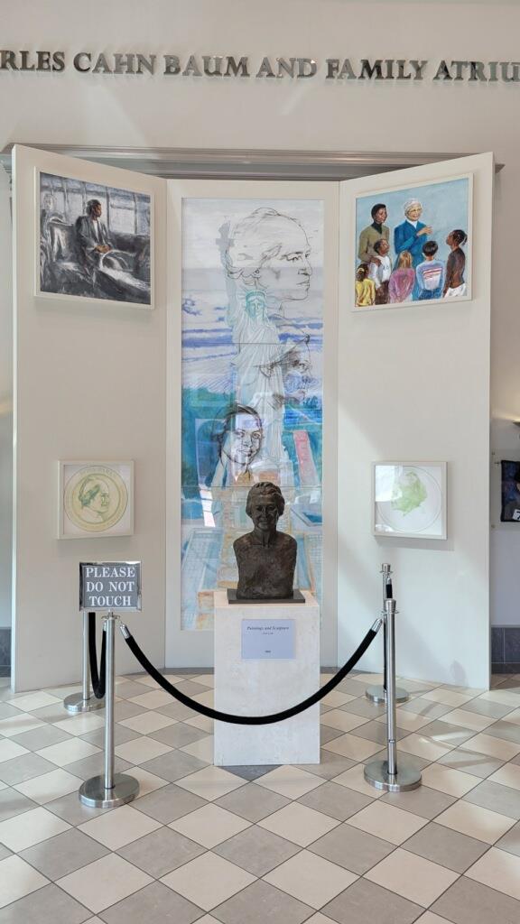 Exhibition space showcasing historical items, including a display on the left and informational boards in the center.