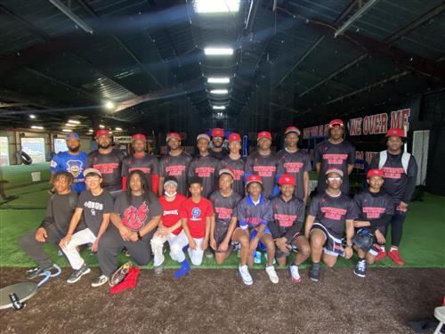 Team photo of a sports team posing with their coach.