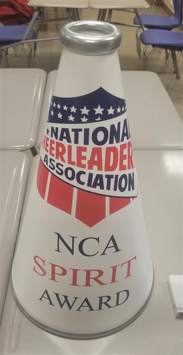 National Cheerleader Association NC Spirit Award trophy on a desk.