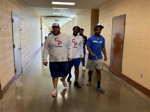 Group of people in a hallway.