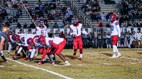 Team of football players on the field during a game.