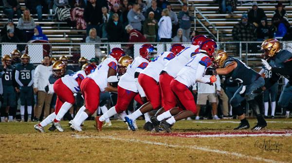 High school football team in action on the field during a game.