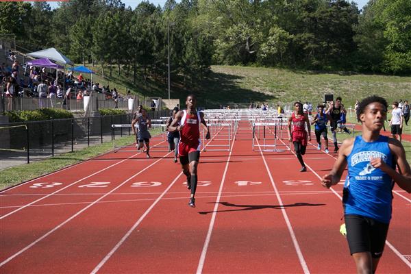 A group of runners participating in a race on a track.