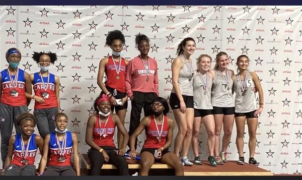 A group of athletes celebrating their achievements at a competition.