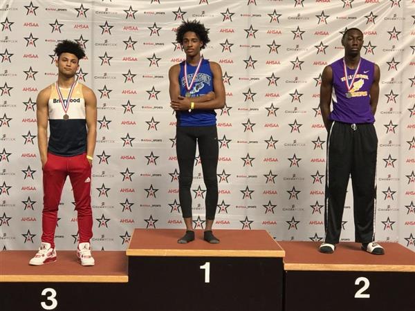 Three athletes on a podium at a competition.