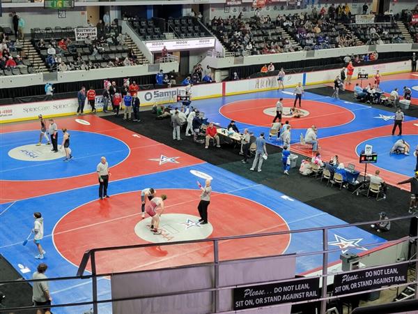 A lively indoor wrestling match in progress.