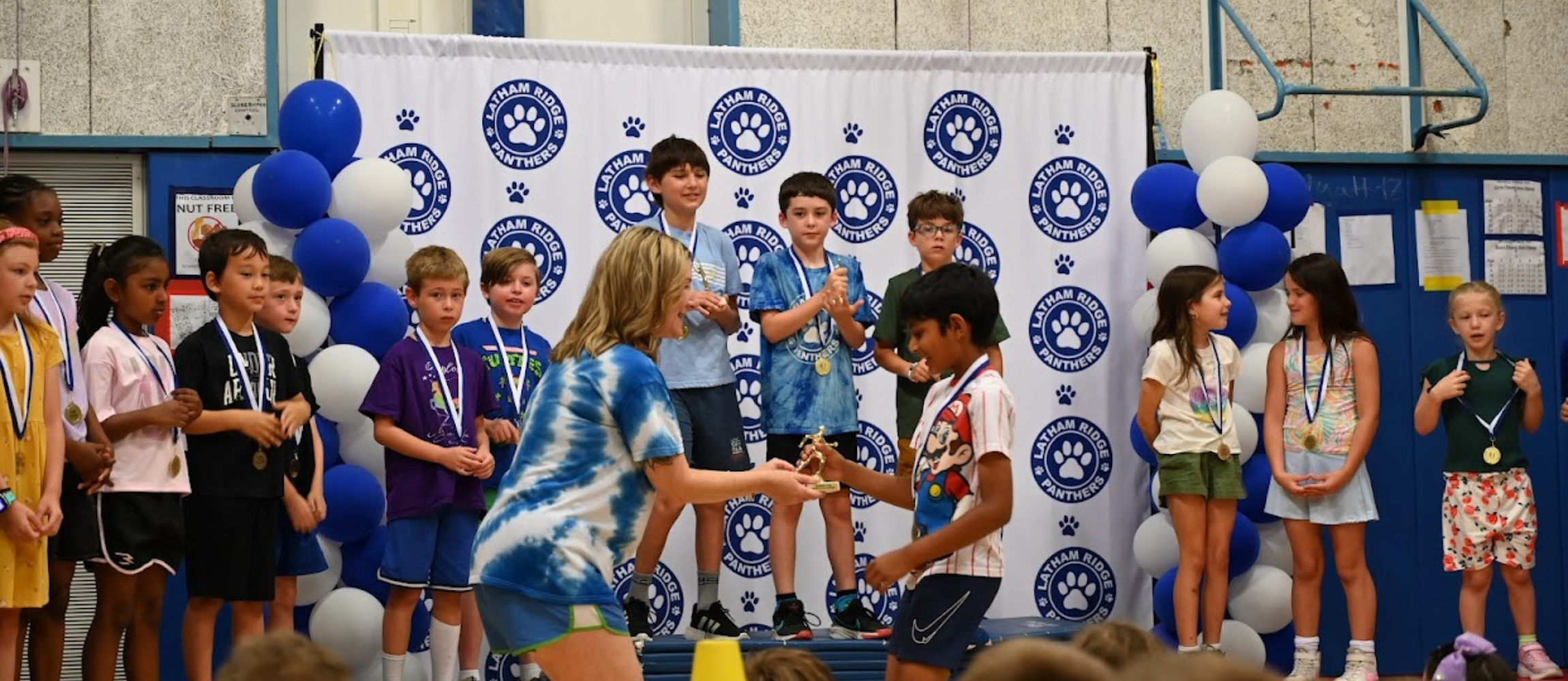 student receiving award at latham ridge running club awards  