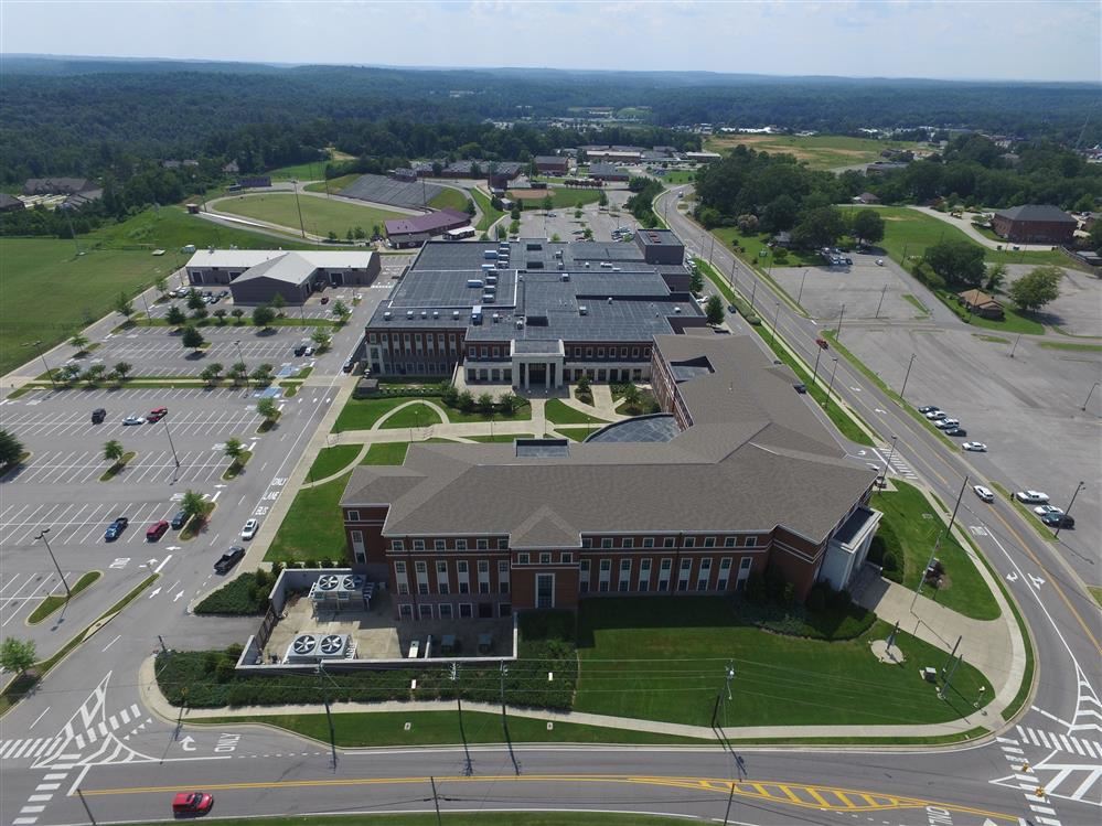 The school building with a parking lot.