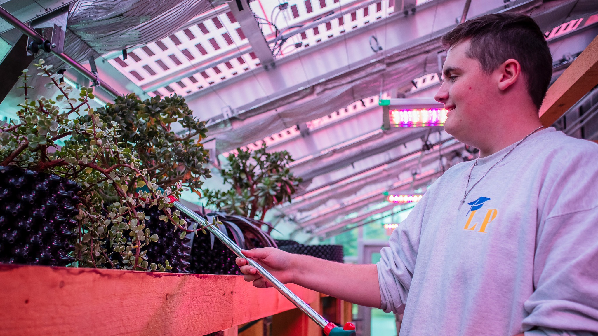 student watering plants