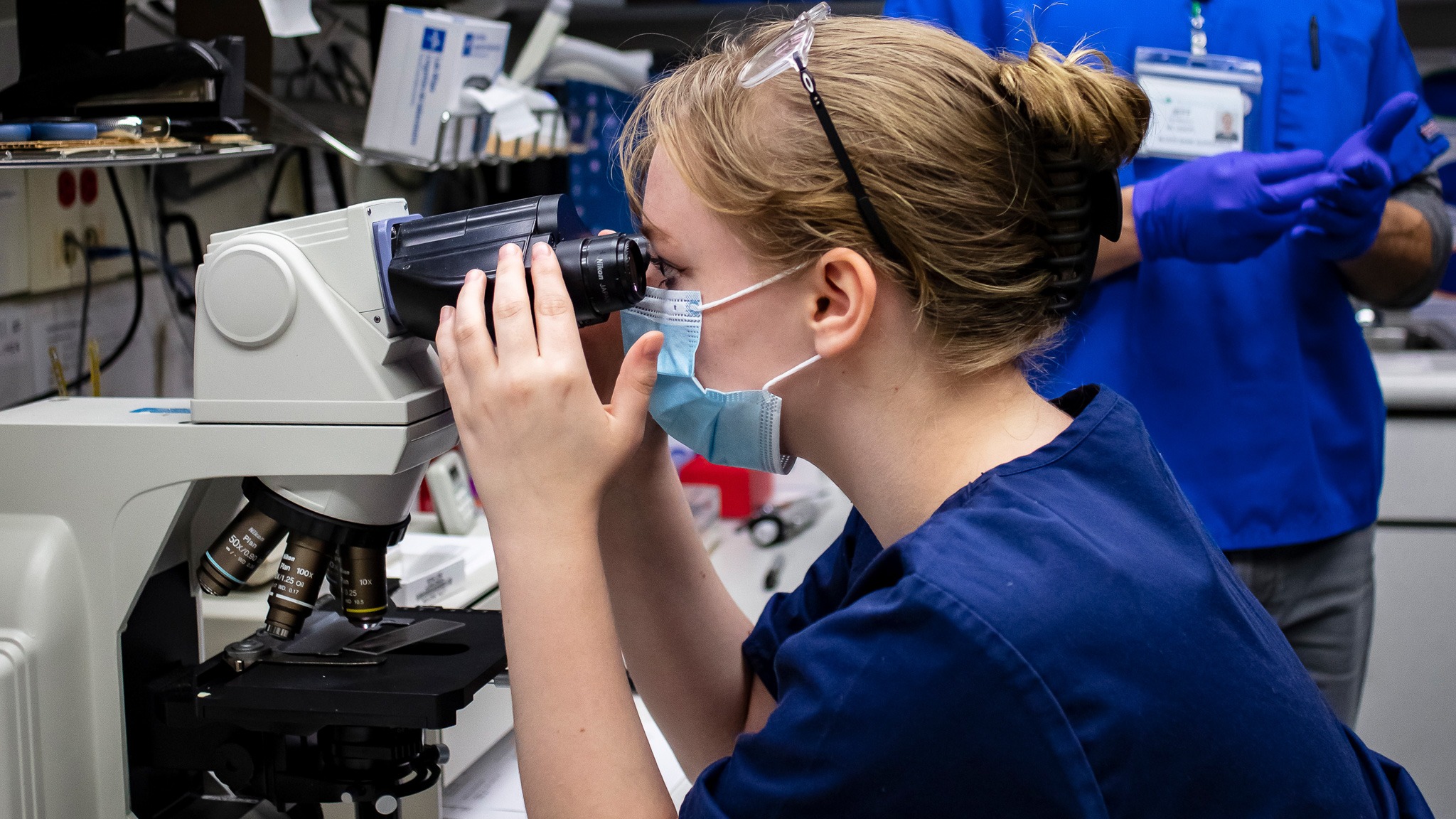 Student looking into microscope