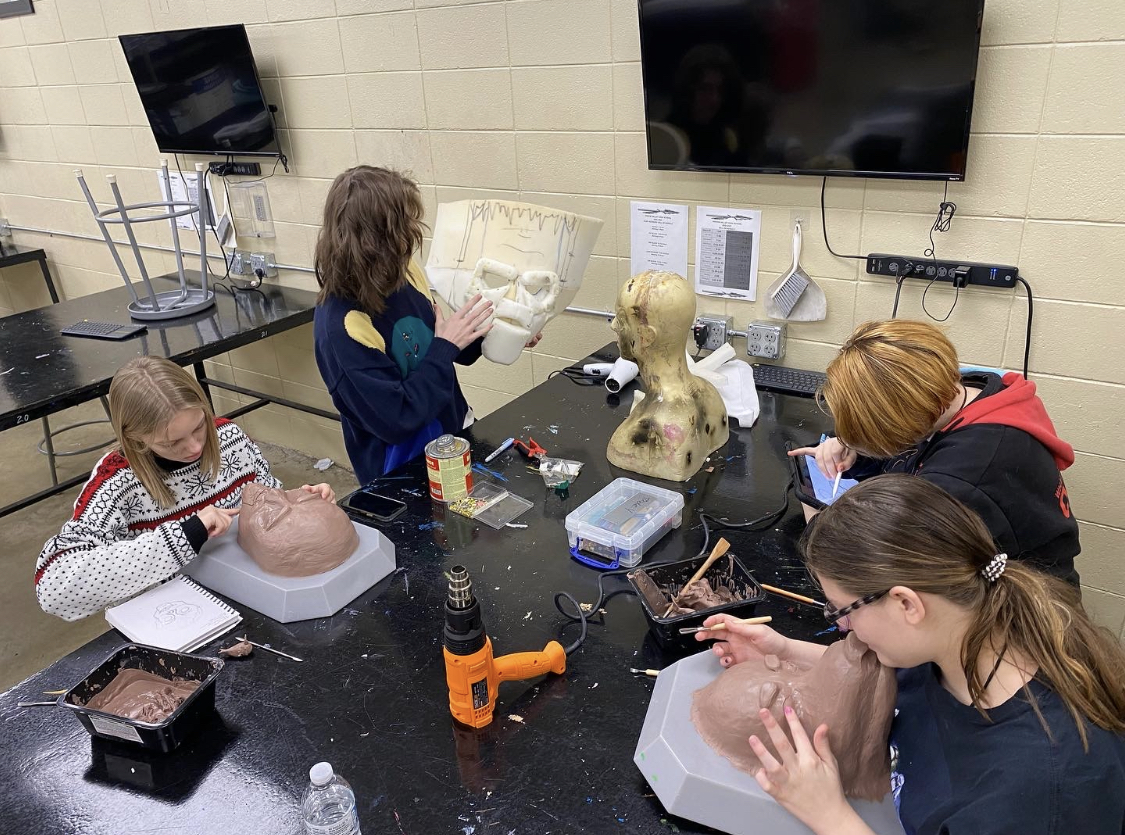 Special Effects students around a table working on a head model project 