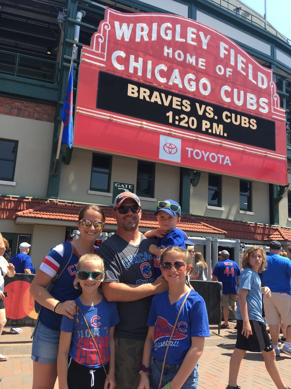 A photo of Mrs. Weller, a teacher at School Readiness Preschool, and her family at Wrigley Field