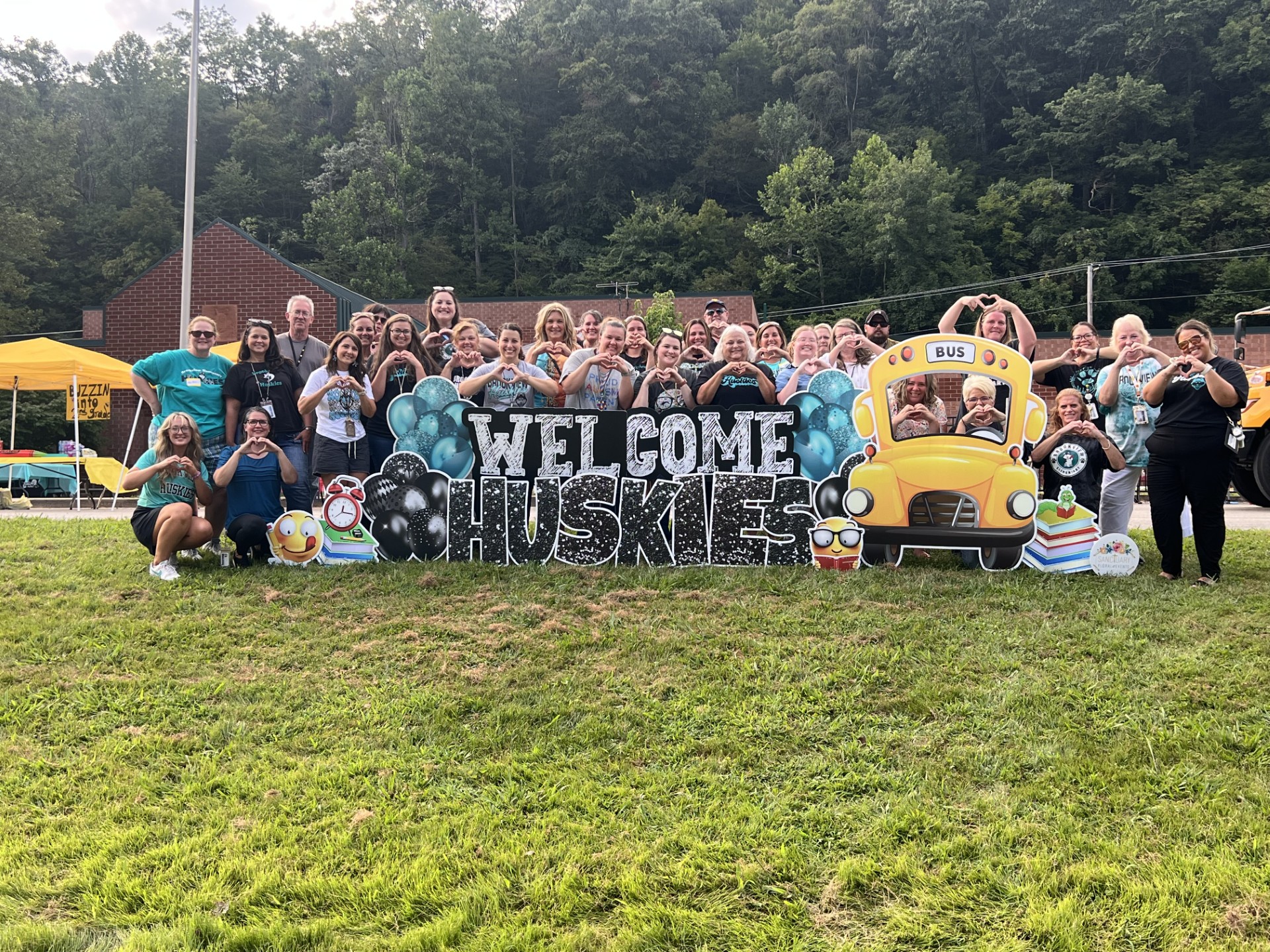 Brookview staff behind welcome back Huskies sign