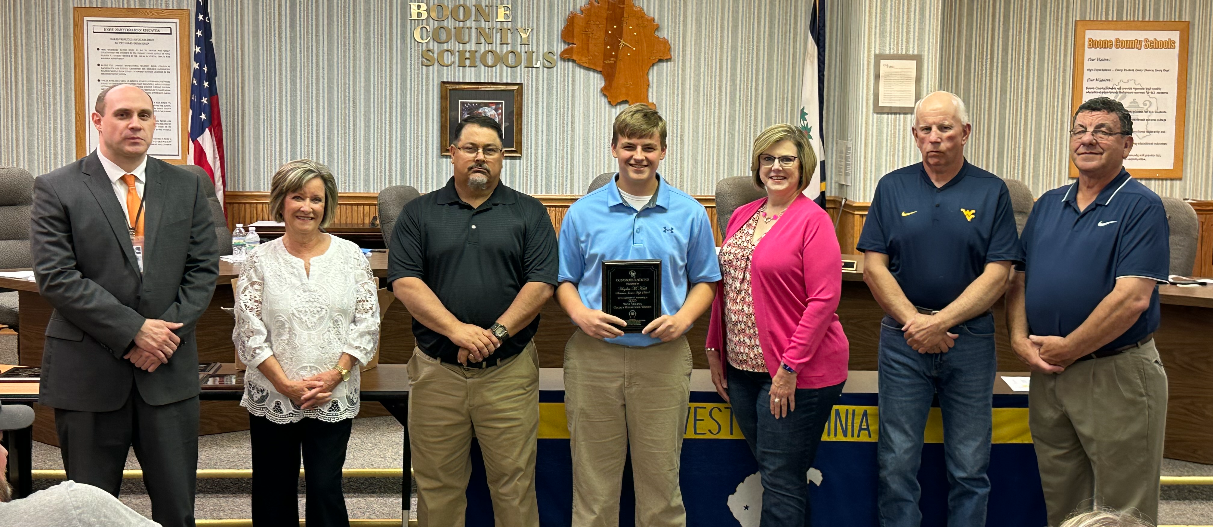 people smiling with award